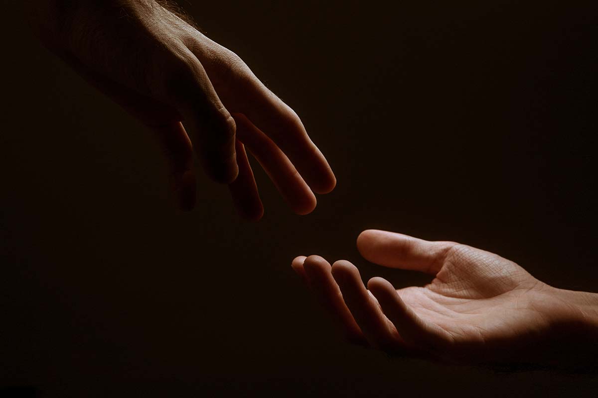 Hands reaching for each other