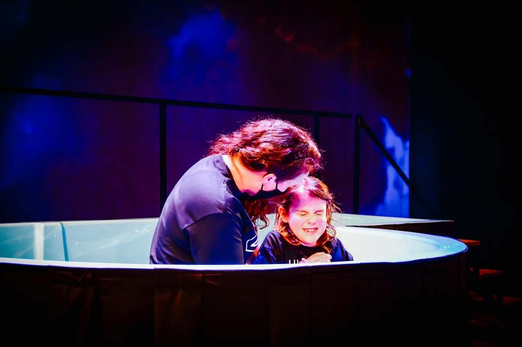 a mother baptizes her daughter in church