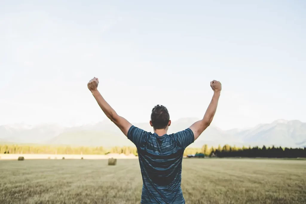 Man celebrating becoming debt-free